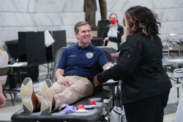 Gov. Andy Beshear gives blood at Team Kentucky Saves Lives blood drive.